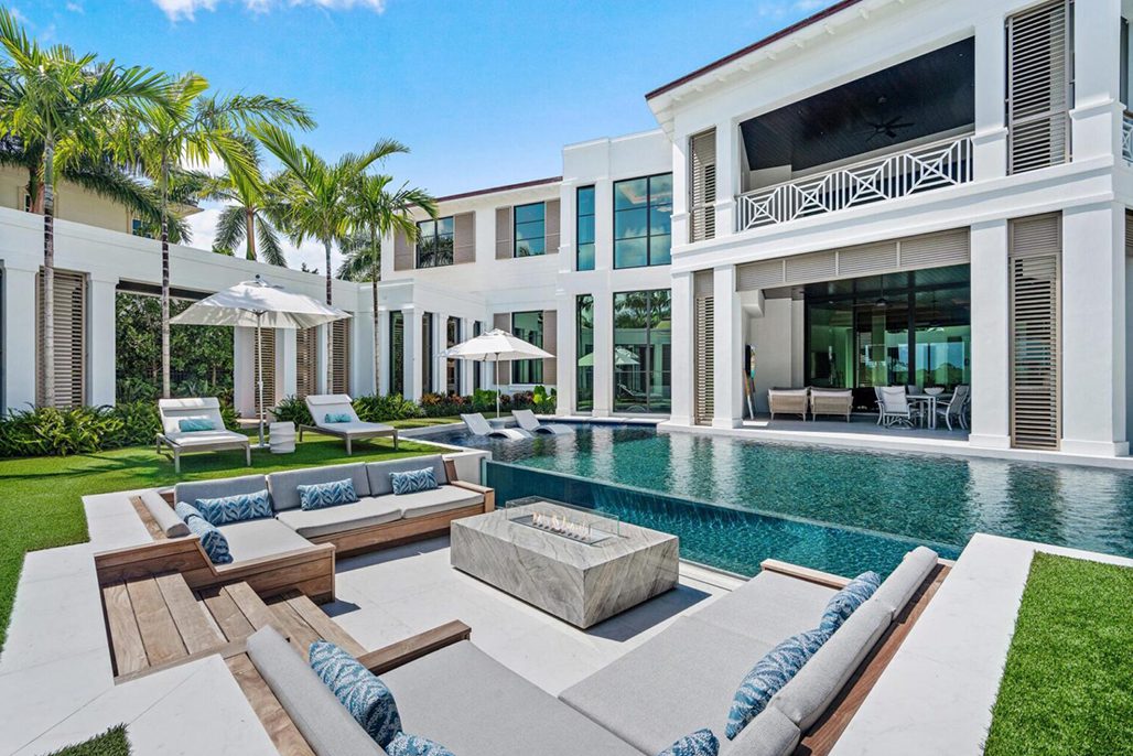 Luxury poolside patio with modern furniture.
