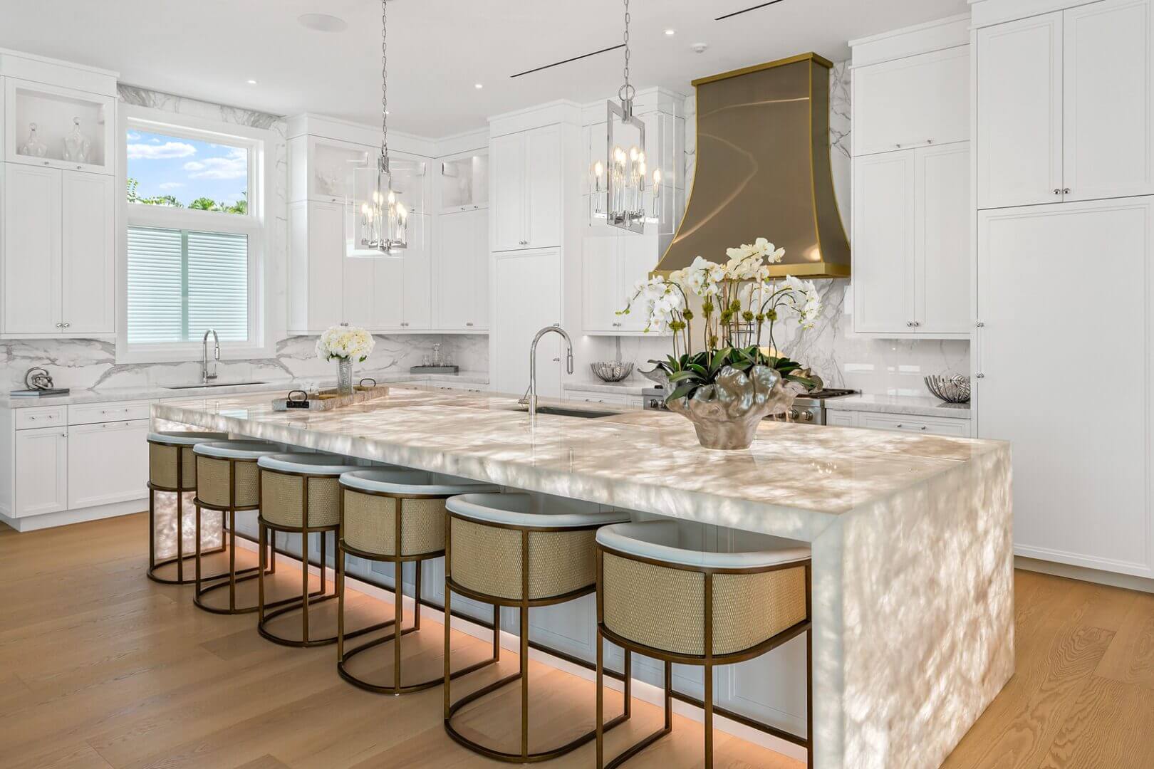 Luxurious kitchen with large island and stools.
